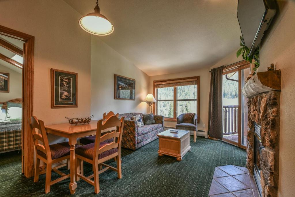 a living room with a table and a couch at Hidden River Lodge 5995 in Keystone