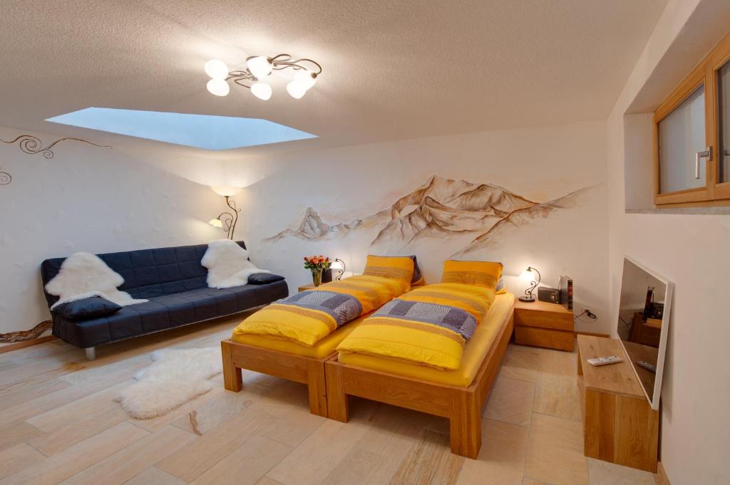 ein Wohnzimmer mit einem Bett und einem Sofa in der Unterkunft Chalet Alpoase in Zermatt