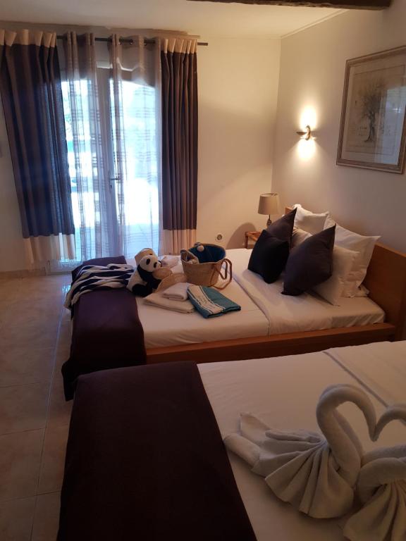 a bedroom with two beds with stuffed animals on them at Hotel Villa Maya in Saint-Tropez