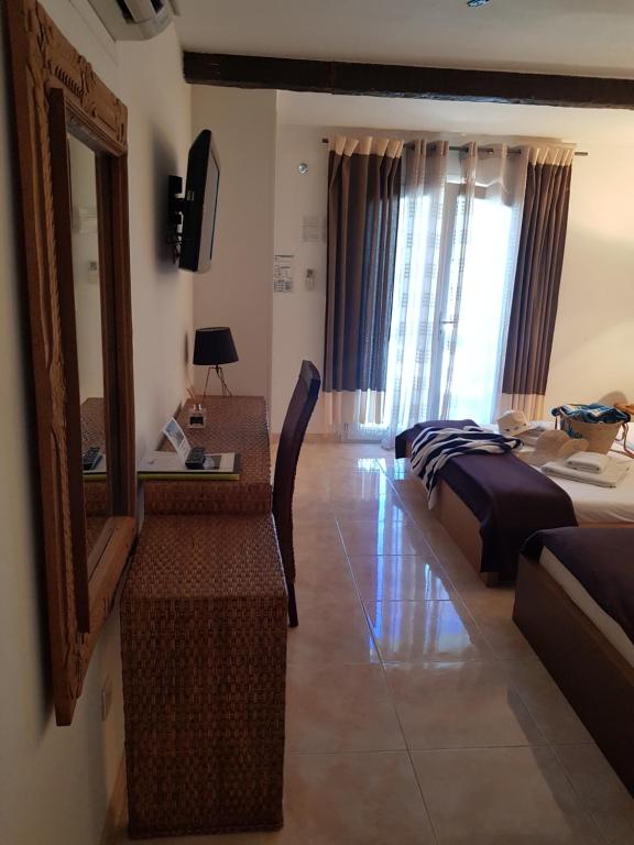 a hotel room with a bed and a mirror at Hotel Villa Maya in Saint-Tropez