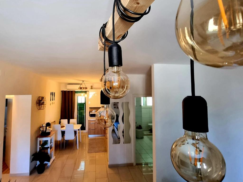 a room with several glass lights hanging from the ceiling at Apartment Lux Zadar in Zadar