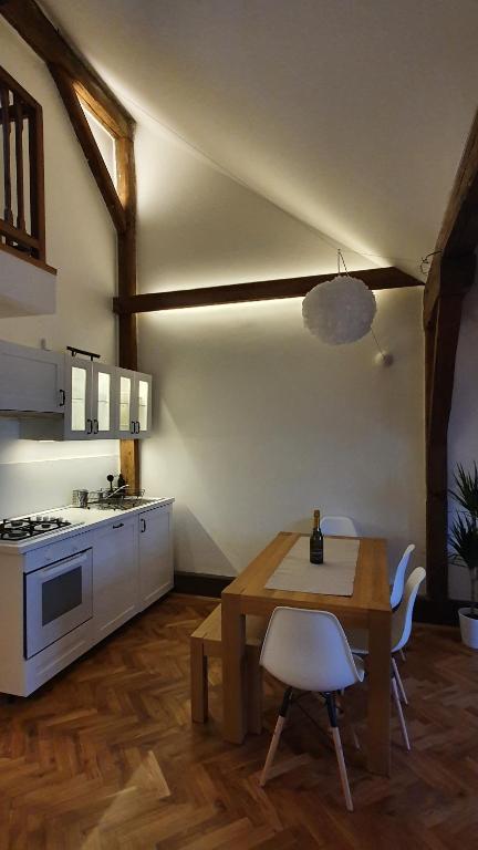 a kitchen with a wooden table and a dining room at Prague Castle View Apartment in Prague