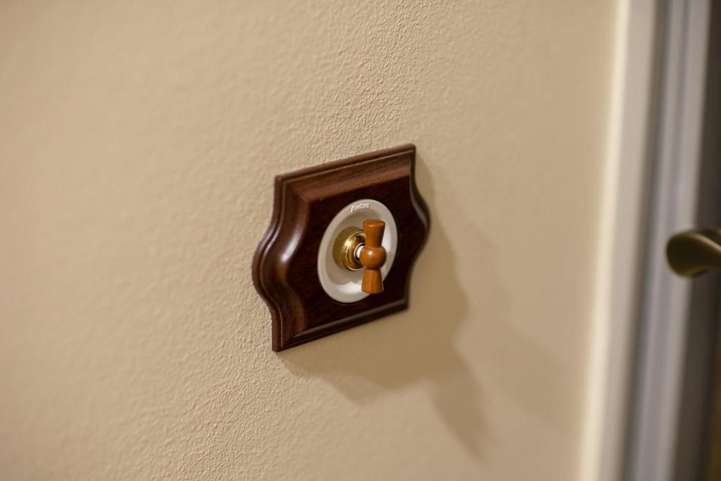 a brown door knob on a white wall at Hotel St. Barbara in Tallinn