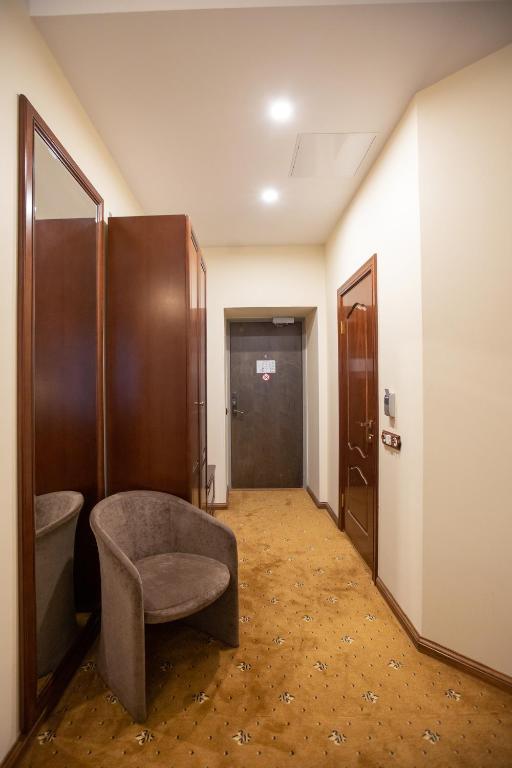 a bathroom with a chair in a hallway at Hotel St. Barbara in Tallinn