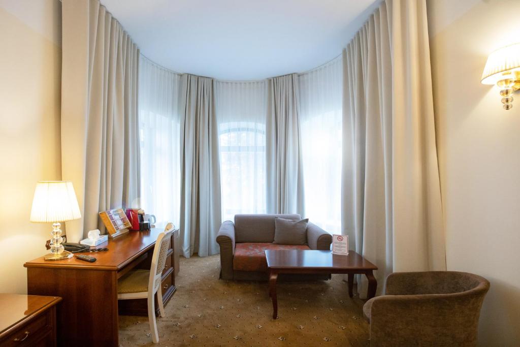 a living room with a couch and a table at Hotel St. Barbara in Tallinn