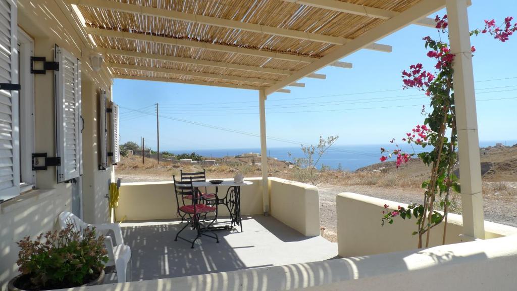 a porch with a view of the ocean at Drakkar Houses in Fira