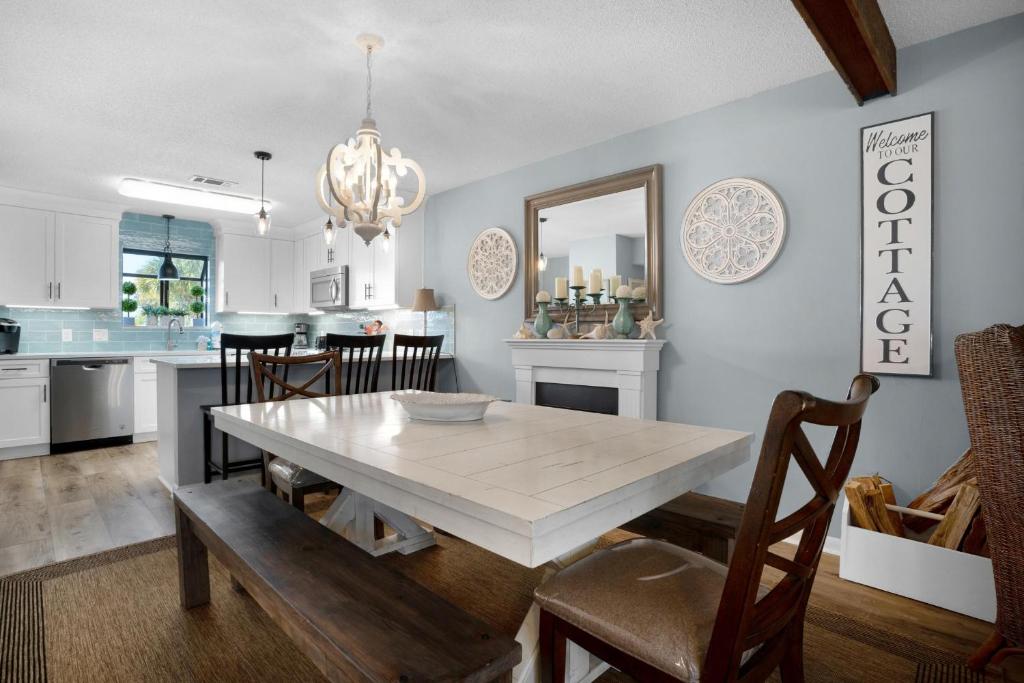 a kitchen and dining room with a table and chairs at Misty Cove 109 in Destin