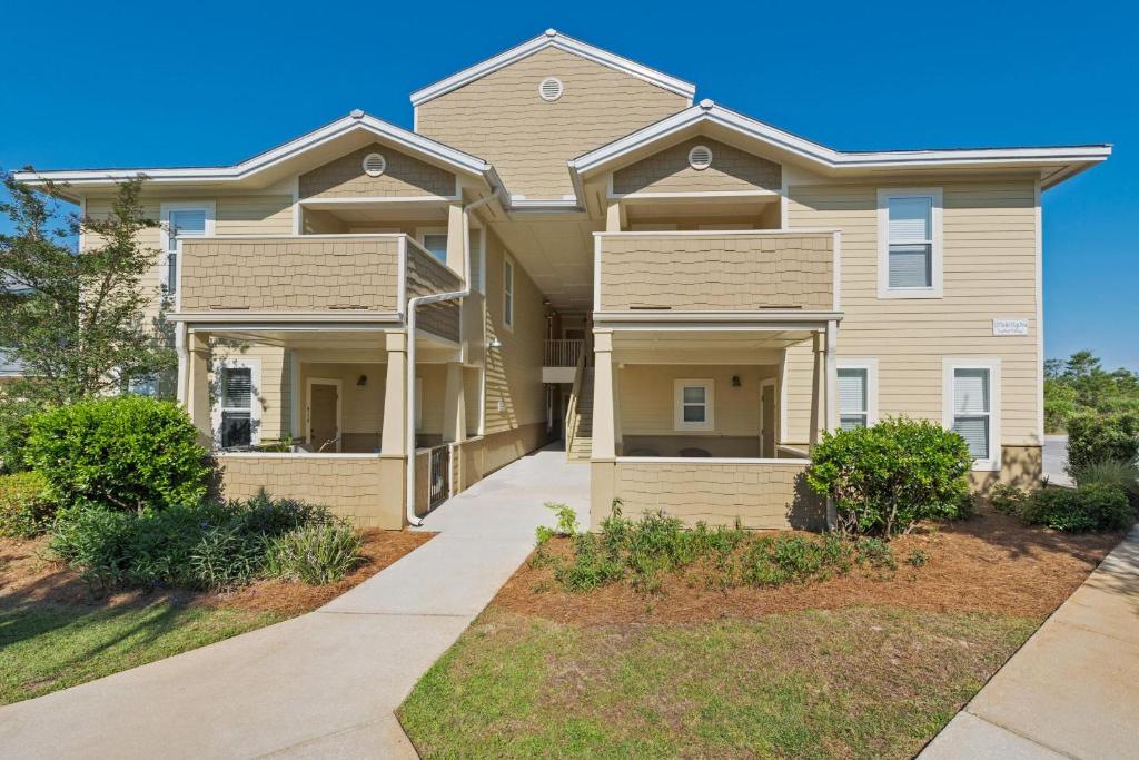 a house with a pathway in front of it at Topsail Village 422 in Santa Rosa Beach