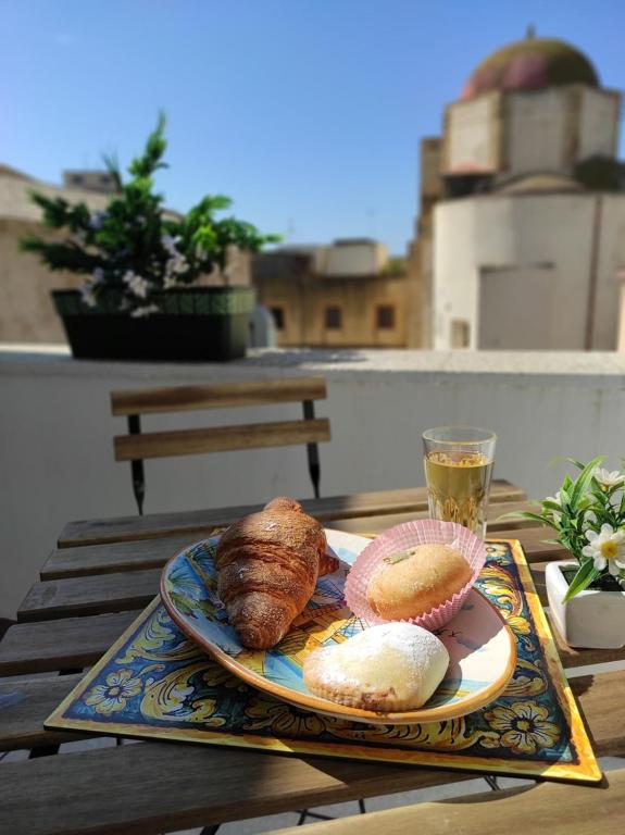 a plate of bread and a drink on a table at Da Marilù in Mazara del Vallo