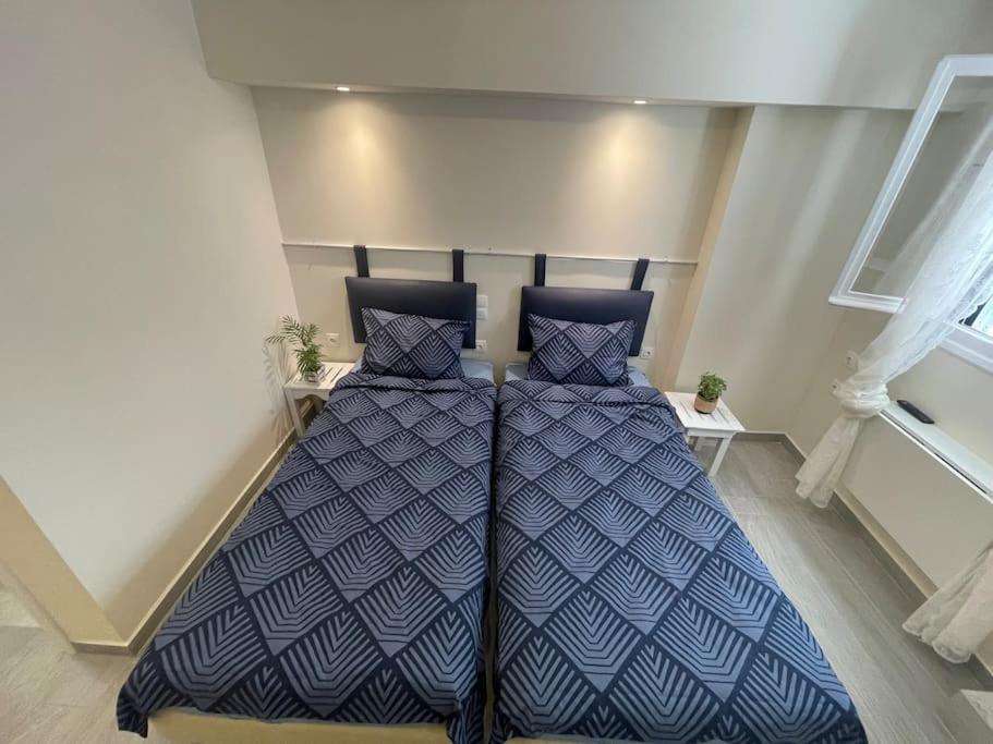 a bedroom with a bed and two pillows on it at Vatos Studio in Vátos