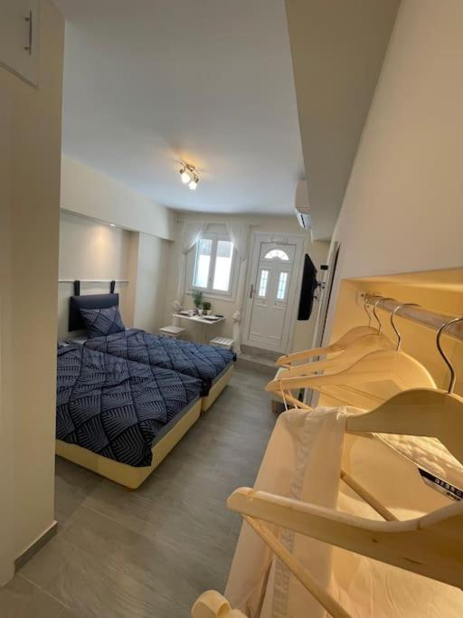 a bedroom with a bed and two chairs in it at Vatos Studio in Vátos