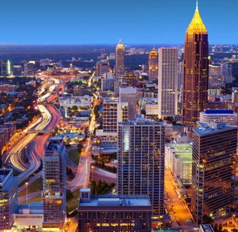 a view of a city at night with traffic at Wine Down Suite King Bd, 400mbps, Kitchen,Free Parking Pool in Atlanta