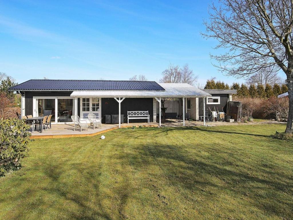 a house with a solar roof on a yard at Holiday home Jægerspris XLI in Jægerspris