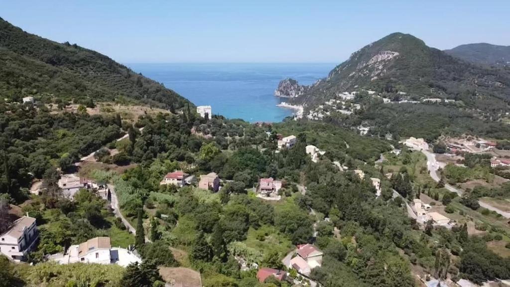 an aerial view of a village on a hill with the ocean at Vatos Studio in Vátos