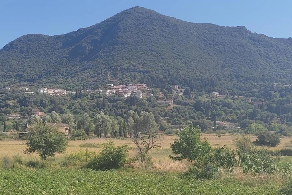 a mountain with a town on top of it at Vatos Studio in Vátos
