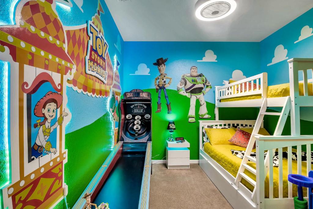 a room with two bunk beds and a roller coaster at Magical Adventure Condo w Waterpark near Disney No Resort Fees in Orlando