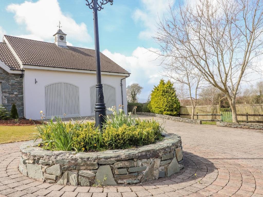 a street light in a stone circle in front of a house at Rosnacarthna More Apartment in Killarney