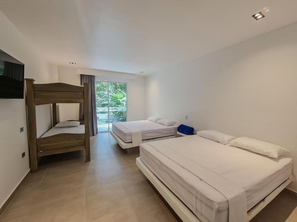 Postel nebo postele na pokoji v ubytování Hotel Monte Bello