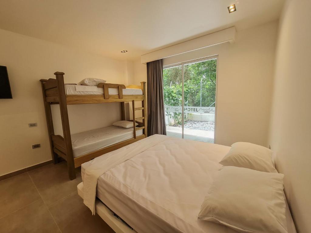 Postel nebo postele na pokoji v ubytování Hotel Monte Bello