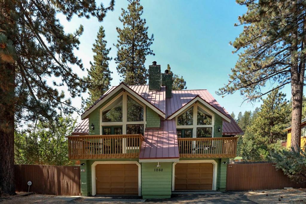 a house with a deck on top of it at Fawnskin Chalet-1826 by Big Bear Vacations in Fawnskin