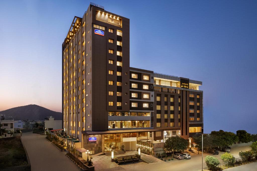 ein Bild eines hohen Gebäudes mit Licht in der Unterkunft Howard Johnson by Wyndham Udaipur Roop Nagar in Udaipur