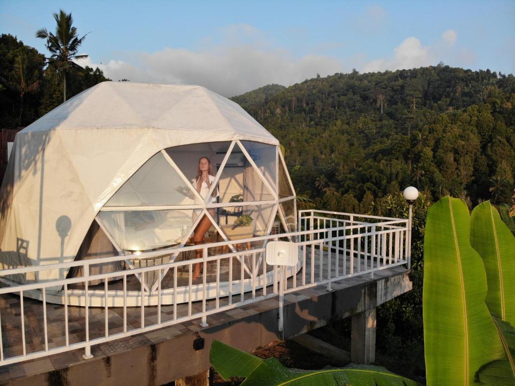 a woman in a dome tent on a bridge at Moondock Luxury Camp in Munduk
