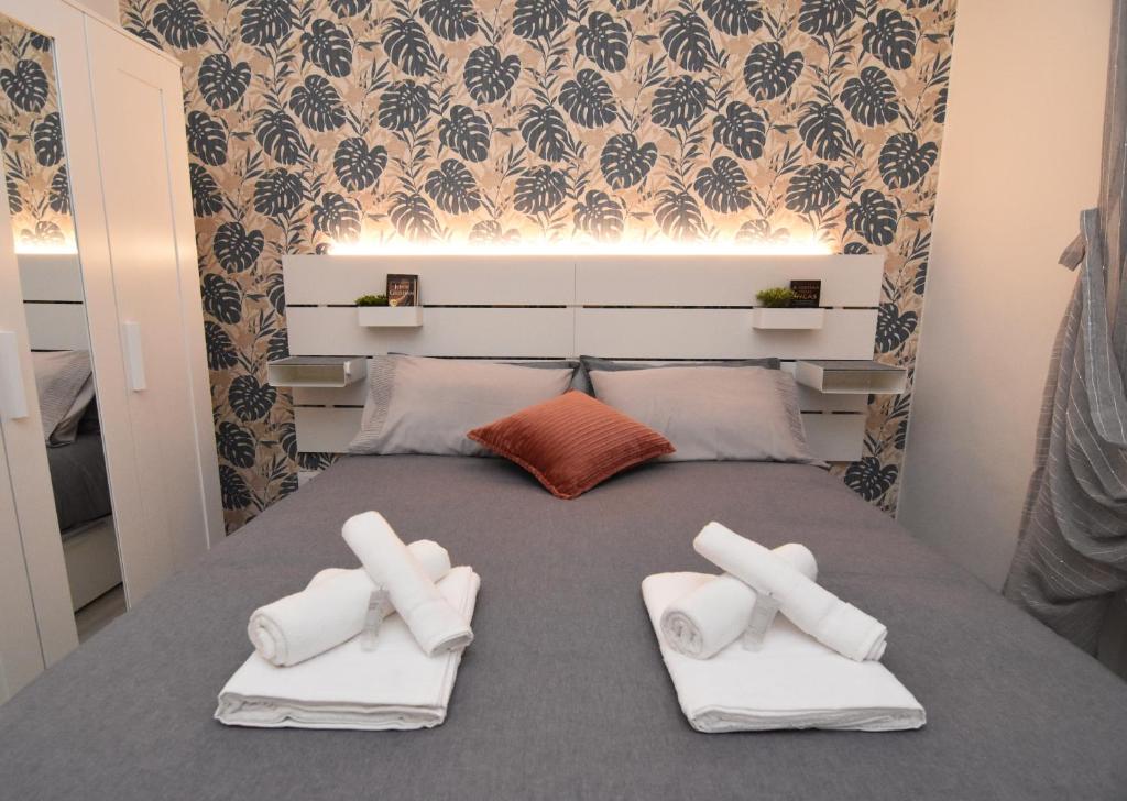 a bed with three pillows on top of it at BLhouse in Turin