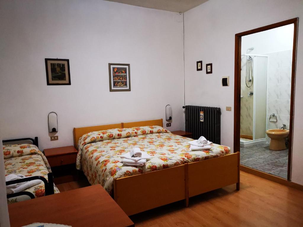 Postel nebo postele na pokoji v ubytování Osteria dei Locandieri