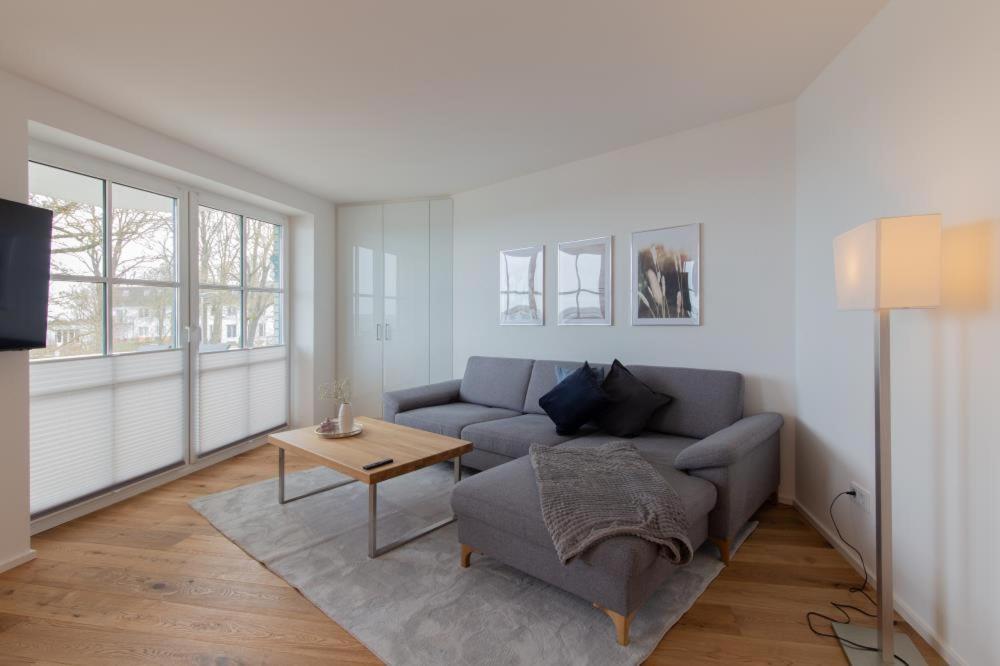 a living room with a couch and a table at Ferienwohung BeachSide No 20 in Niendorf