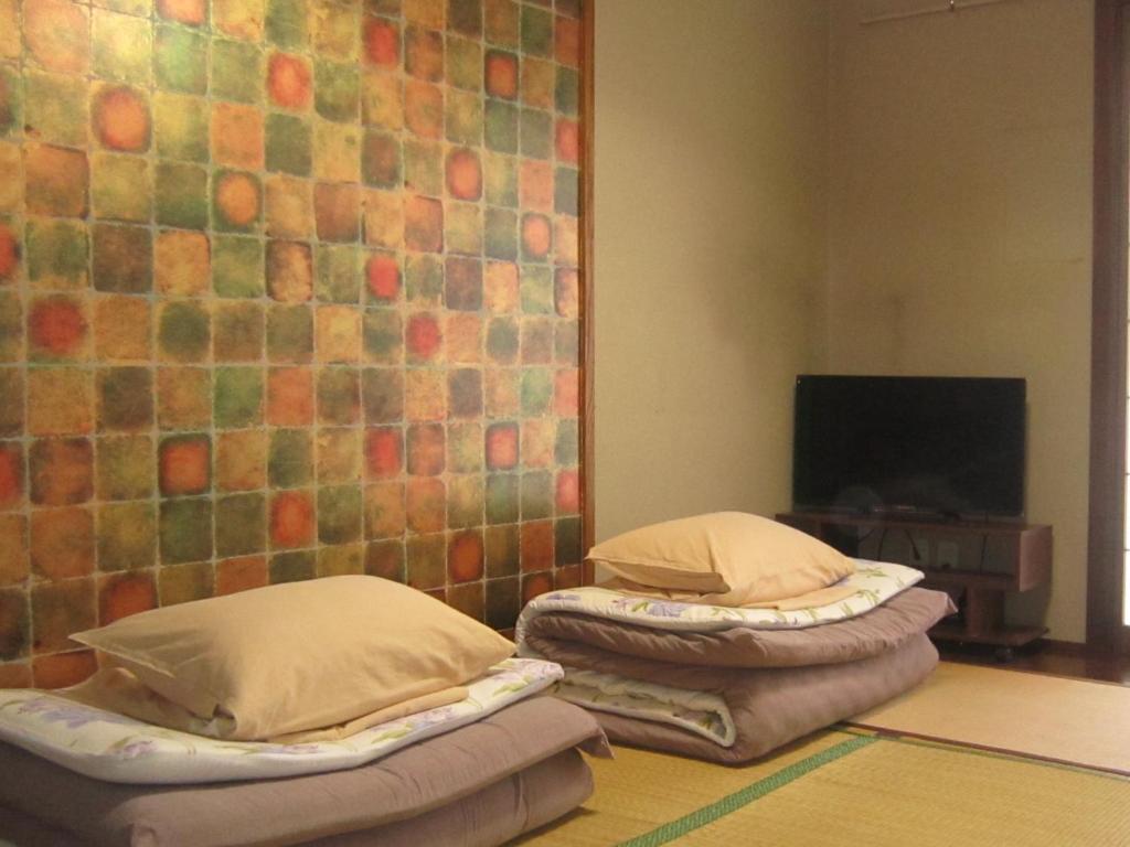 Postel nebo postele na pokoji v ubytování Minato Oasis Numazu / 沼津観光の中心、伊豆観光の拠点に好立地！沼津港に位置し交通・飲食・コンビニ等至便です！