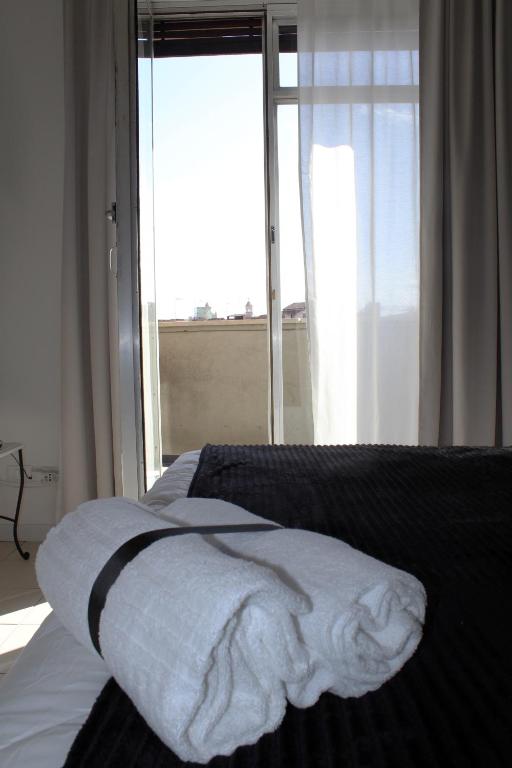 A bed or beds in a room at Essenza del Tempo Inn