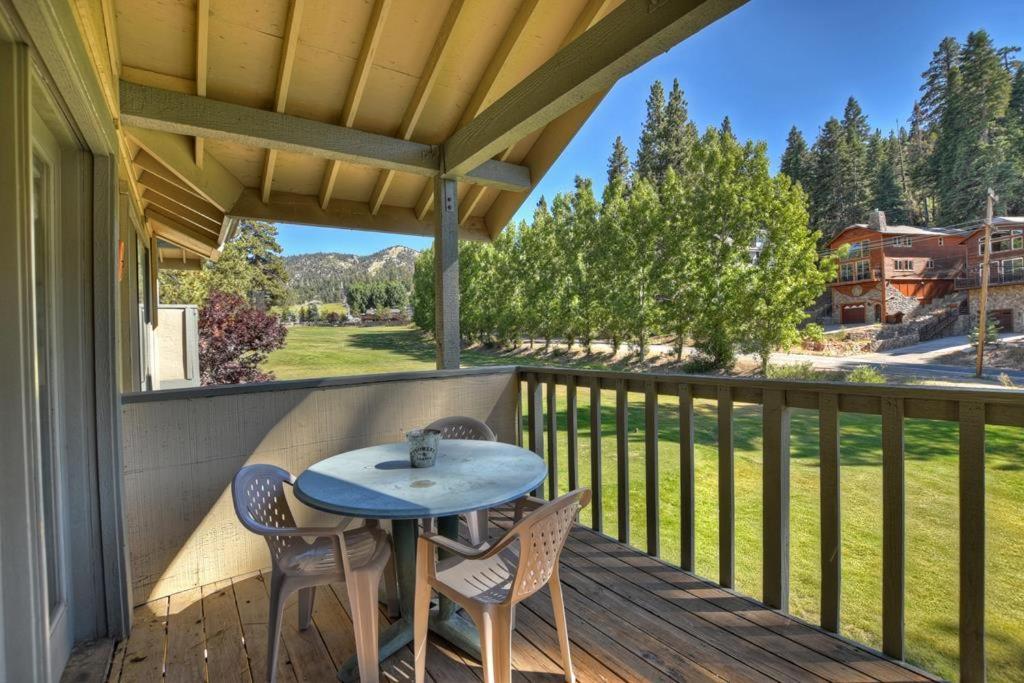 a patio with a table and chairs on a deck at 079 - Golf and Ski in Big Bear Lake