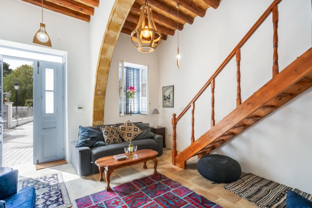 a living room with a couch and a table at To Hani - Kamara Maisonette in Nicosia