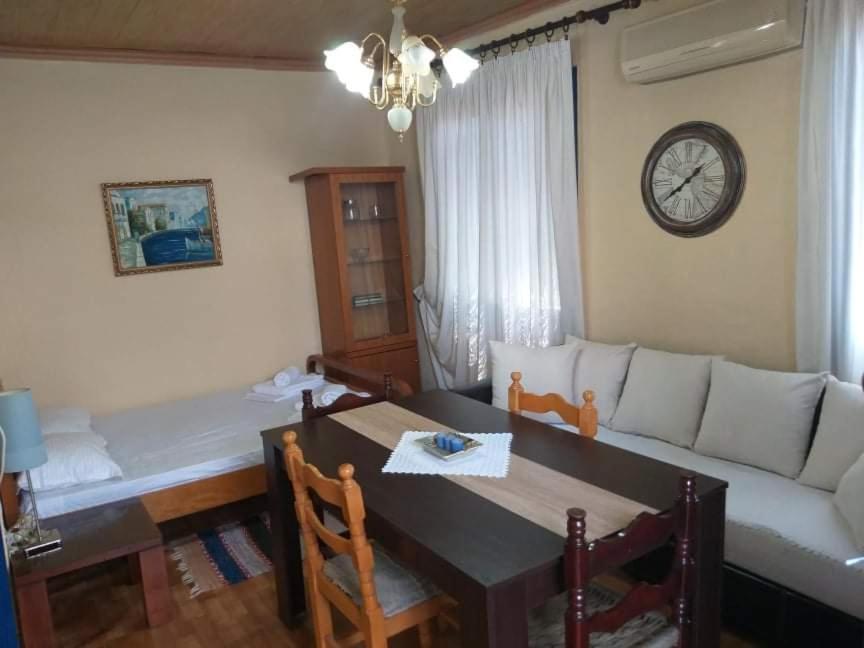 ein Wohnzimmer mit einem Sofa und einem Tisch sowie ein Esszimmer in der Unterkunft Aegean blue in Kallirákhi