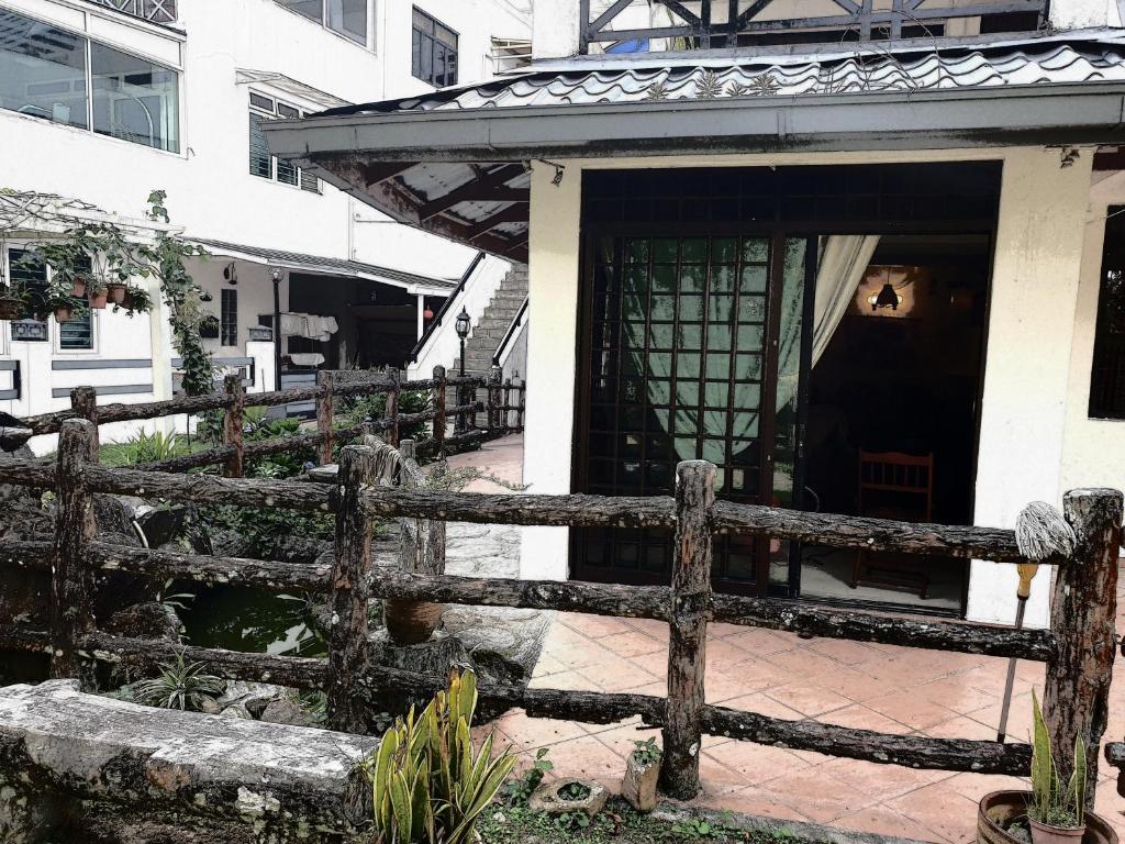 a wooden fence in front of a house at Cool Living at GVR Landed Unit in Genting Highlands