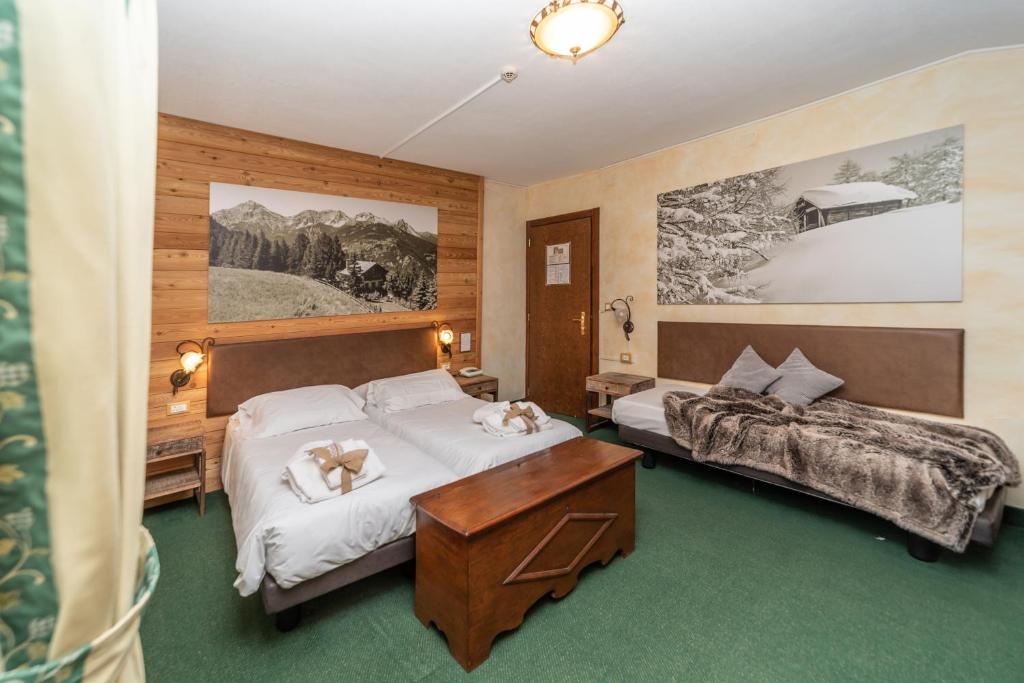 Postel nebo postele na pokoji v ubytování Hotel Gran Baita
