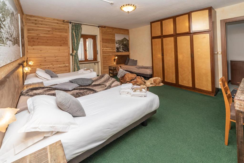 Postel nebo postele na pokoji v ubytování Hotel Gran Baita