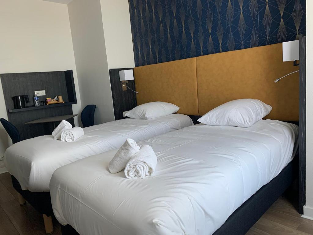 Кровать или кровати в номере Hotel Le Cosy Riva Bella