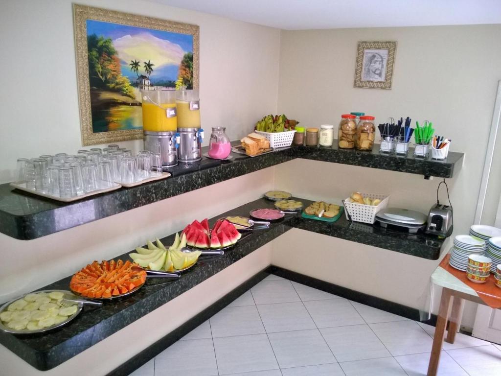 un buffet en una habitación de hotel con platos de comida en Pousada Panorâmica, en Aracaju