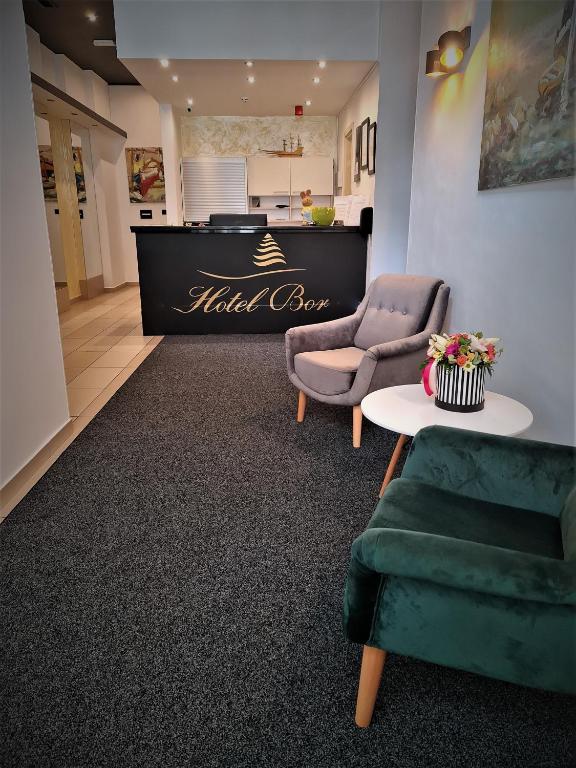 a waiting room with two chairs and a table at Hotel Bor in Krk