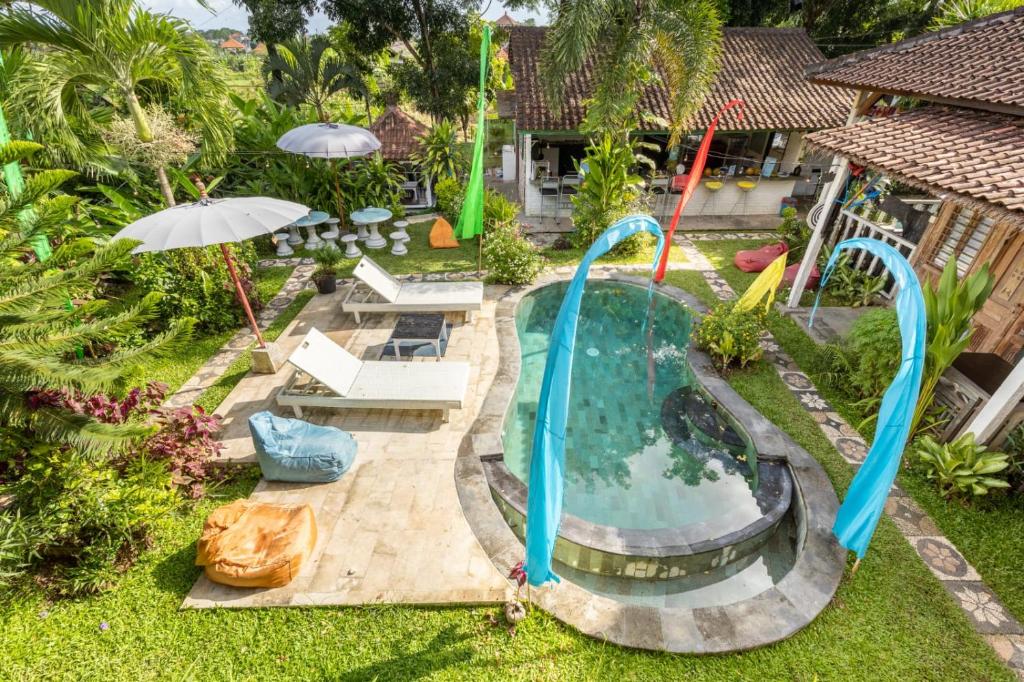 an overhead view of a pool with a water slide at Bali Brothers Guesthouse in Dalung