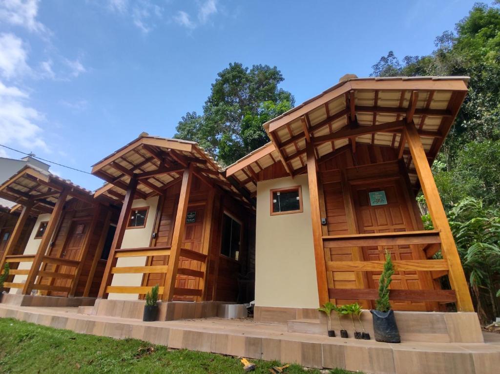 a row of modular homes with wooden doors at Chalés Schwambach in Domingos Martins