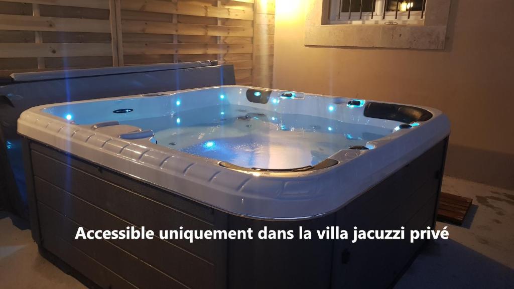 a jacuzzi tub with blue lights in a bathroom at Mas Saint Julien in Cavaillon