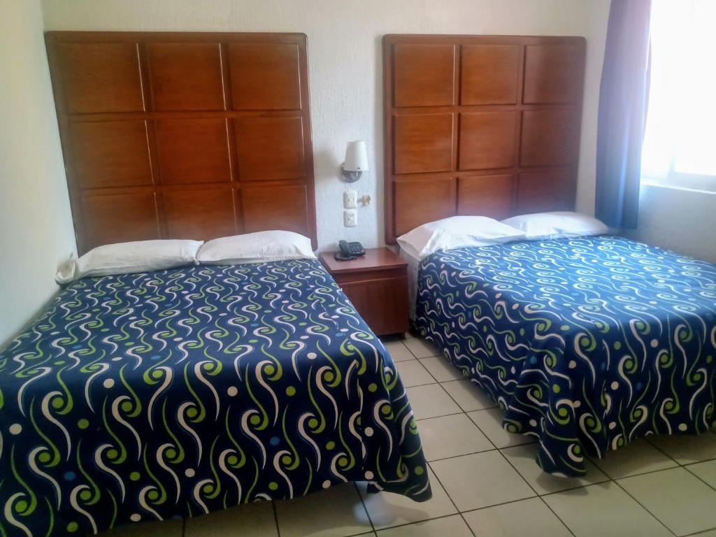 Postel nebo postele na pokoji v ubytování Hotel California