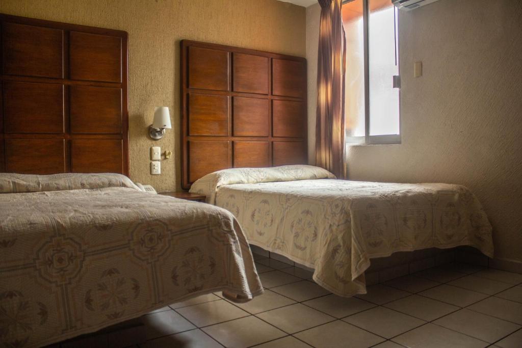 Postel nebo postele na pokoji v ubytování Hotel California