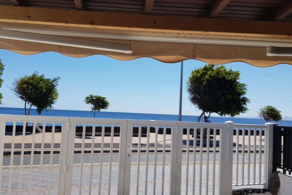 a white fence on the beach with trees at Azul in Puerto del Carmen