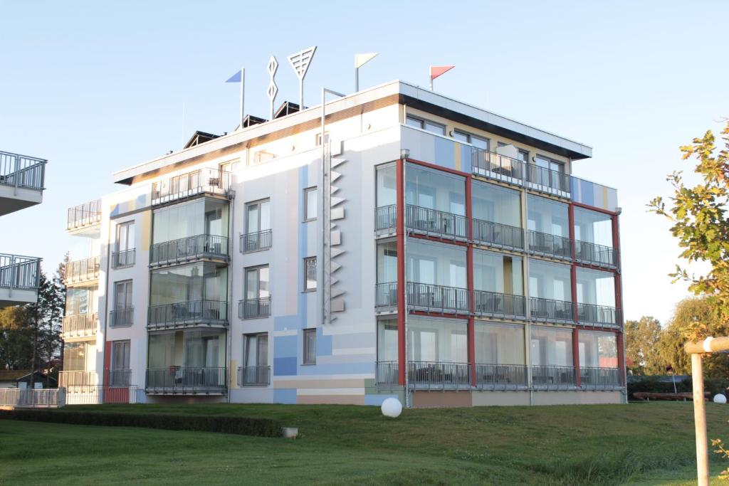 a white building with balconies on the side of it at Ostseedomizil La Mer in Börgerende-Rethwisch