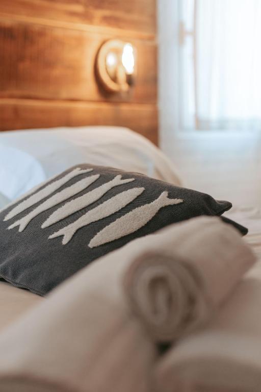 a black and white pillow on a bed at Laguna Suite B&B in Chioggia