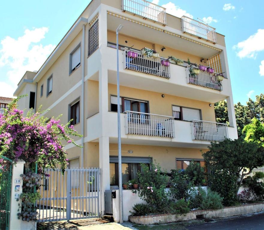 an apartment building with balconies and flowers at La casa di Antonio in Briatico