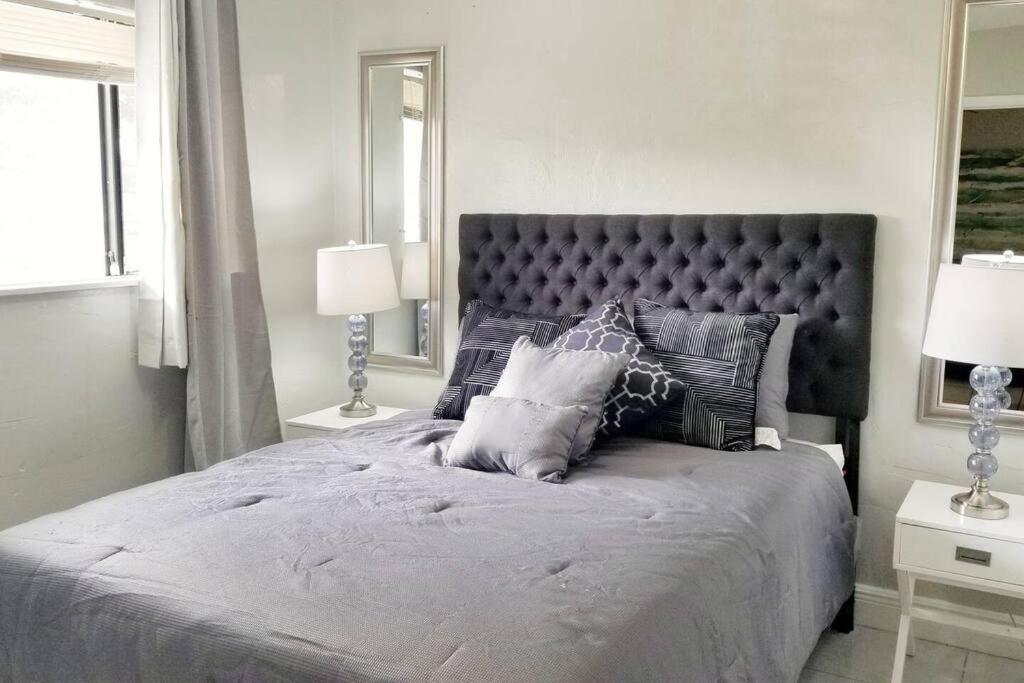 a bedroom with a large bed with two lamps at Ultra Glam Apartment 6 Miles From Hard Rock Stadium and Casino in Hollywood